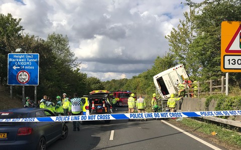 Dozens injured after coach overturns on M25, as baby is born at scene
