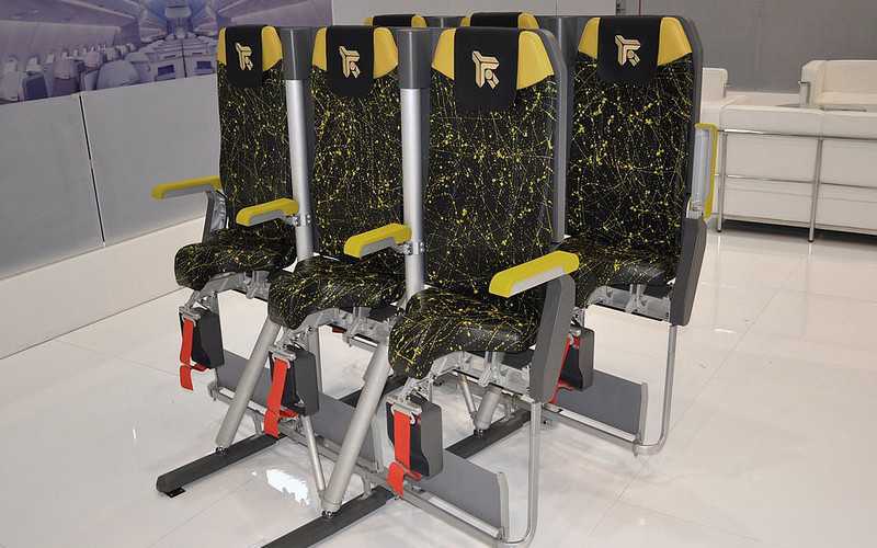 Manufacturer hones its design of an upright seat passengers have to stand to use