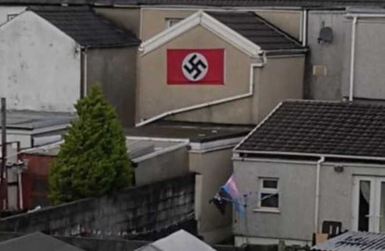 Man arrested after huge swastika flag spotted on back of house