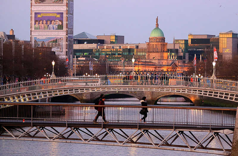 Dubliners hang jackets and coats on the bridge to help the homeless