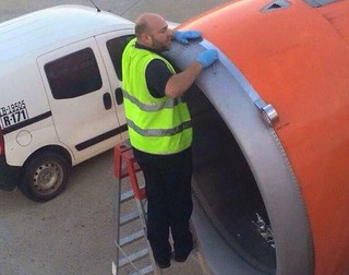 Shocked easyJet passenger takes photo of airport worker applying 'tape' on engine 