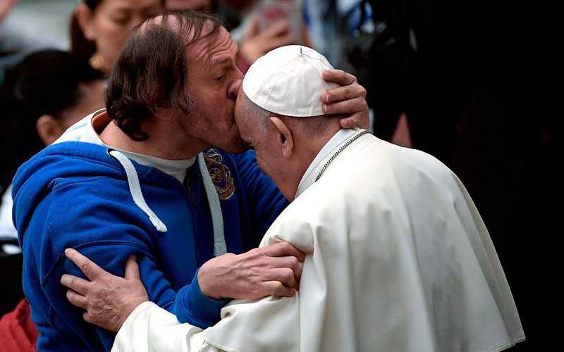 Pope tenderly kissed on forehead by man in front-row seat