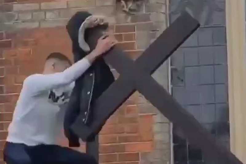 A vandal was arrested who tore the cross over the entrance to the church