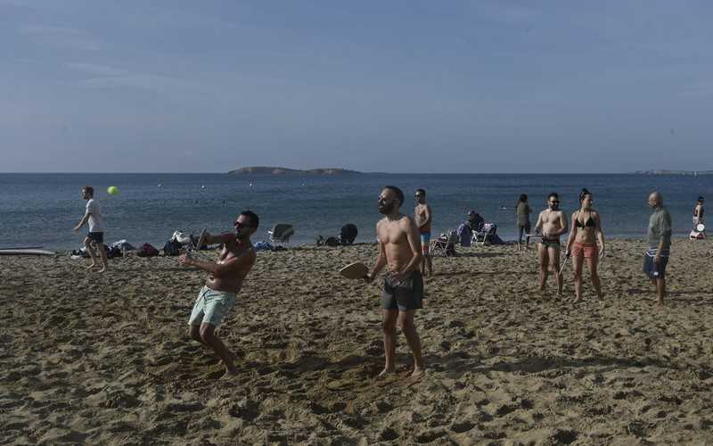 Greeks escape lockdown for the beach as winter temperatures soar