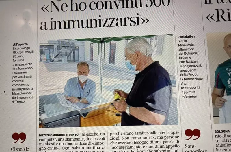 Italy: A doctor sets up a table by the market and encourages vaccinations
