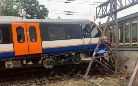 Two injured as train crashes through barriers at north London station