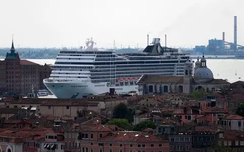 New in Venice: Cruise ship on the roadstead, tourists by boat reached the city