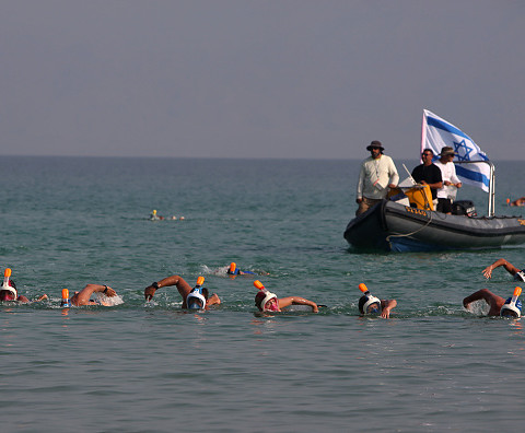 Swimmers cross Dead Sea to highlight shrinking water surface