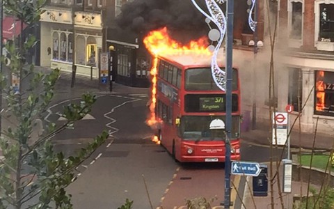 Double-decker bus engulfed by flames as it drives down high street