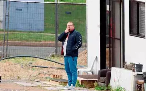 Australia: A scruffy Russian in a tracksuit blocks a plot of land near parliament. He has immunity