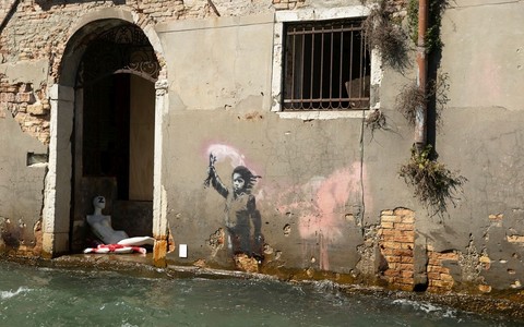 The bank bought a palace in Venice, the facade of which has a work by Banksy