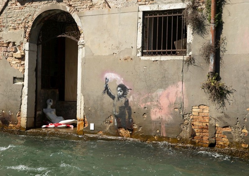 The bank bought a palace in Venice, the facade of which has a work by Banksy