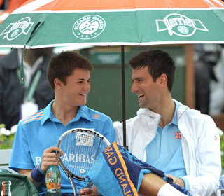 Novak Djokovic makes a ball boy's day during a rain delay at the French Open