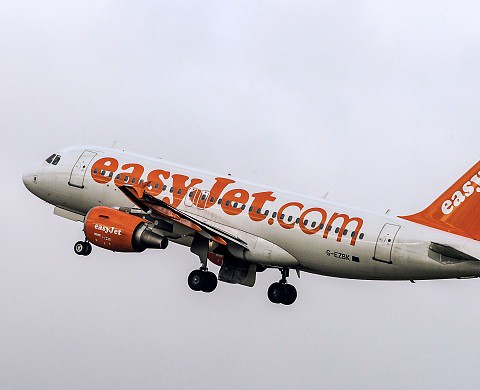 Passengers cheer as woman is escorted off Manchester flight forced into an emergency landing