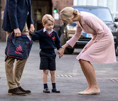 Prince George holds William's hand as he arrives for first day of school