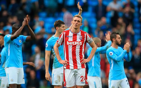 Man City score seven against Stoke to go clear at top