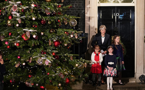 Theresa May joins choir of schoolchildren to turn on the Christmas lights in Downing Street