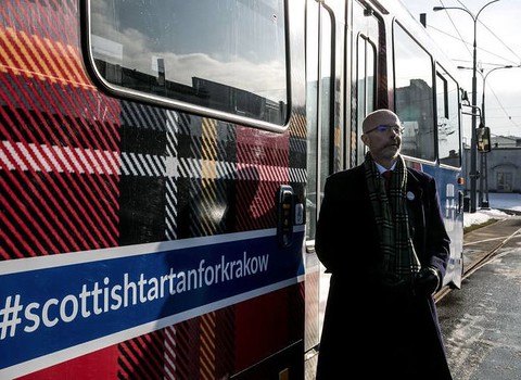 The Ambassador of Great Britain happy with Scottish plaid on trams in Krakow