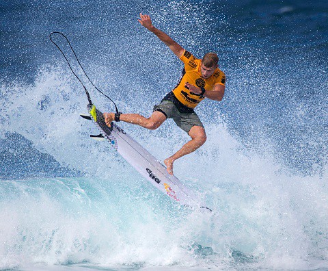 A surfing world champion who survived a shark attack ends his career
