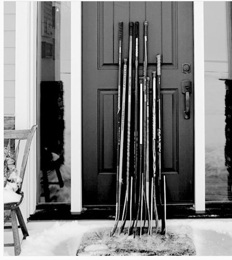 Canadians set hockey sticks in front of the houses in memory of the victims of the accident
